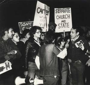 Harvey Milk and Cleve Jones meet the press after Anita Bryant's campaign to repeal anti-discrimination laws passed in Wichita, Kansas, 1978